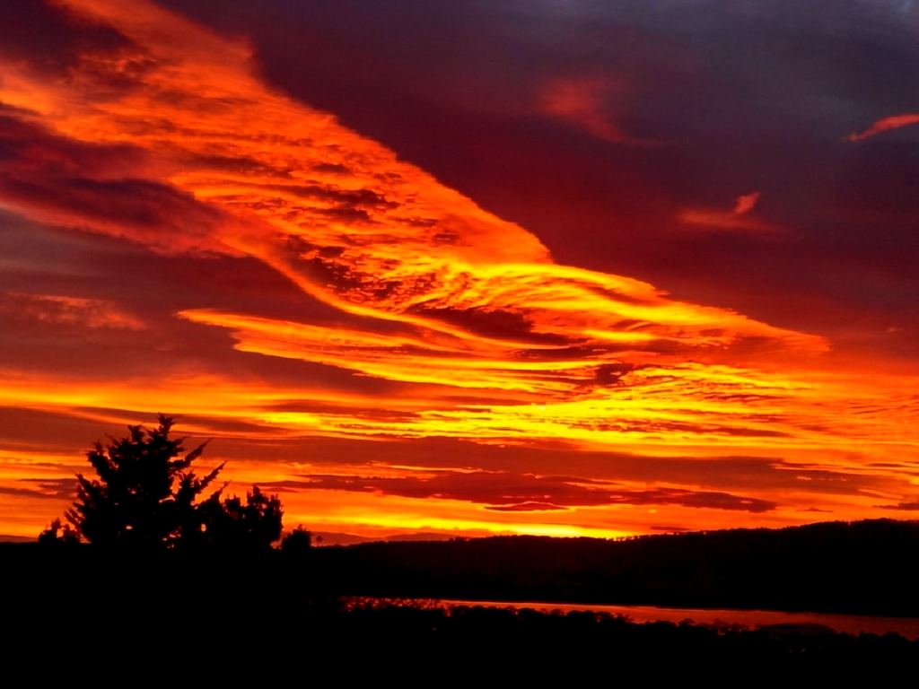 A fiery sunrise over the water