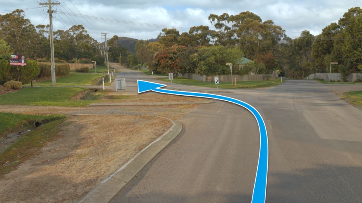 The left turn into Frosts Road, marked with an arrow