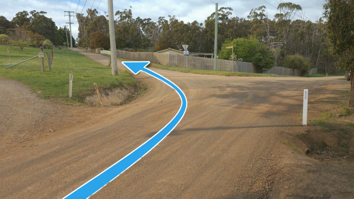 The left turn that stays on Frosts Road, marked with an arrow