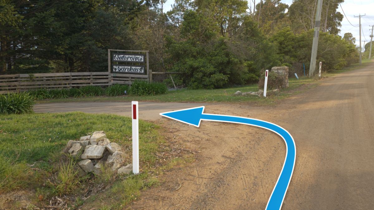 The Waterview Gardens sign at the gate, the way in marked with an arrow